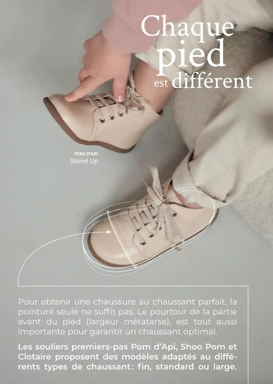 Beige leather lace-up baby boots with soft soles.