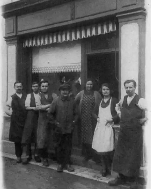 Group of people standing in front of a store entrance.