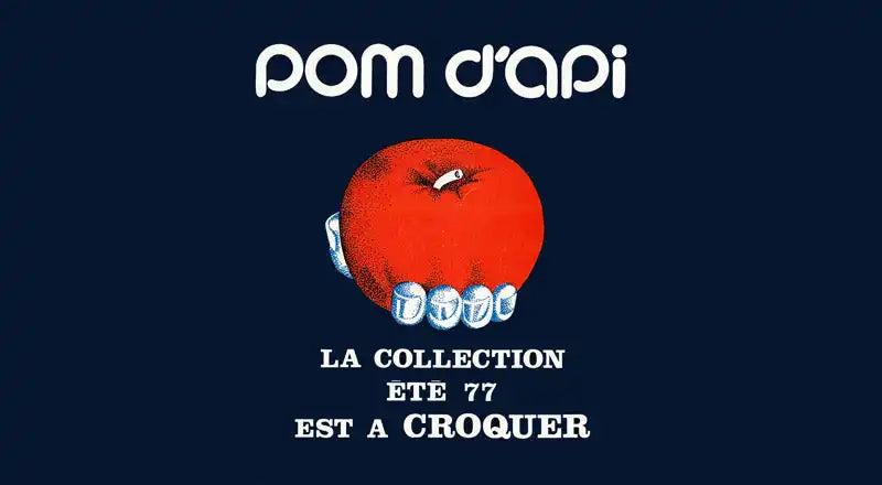 Red apple with white teeth biting into it on a dark blue background.