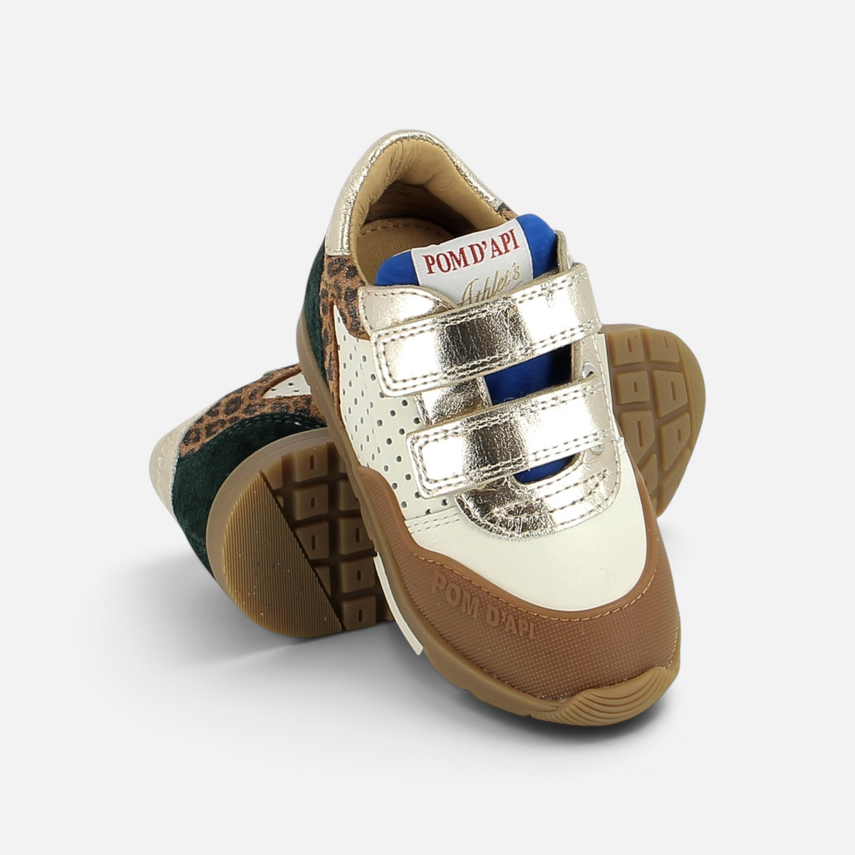 Pom d'Api Pouss Bump sneakers in white and gold leather with leopard-print details, Velcro straps, and a sturdy rubber sole.